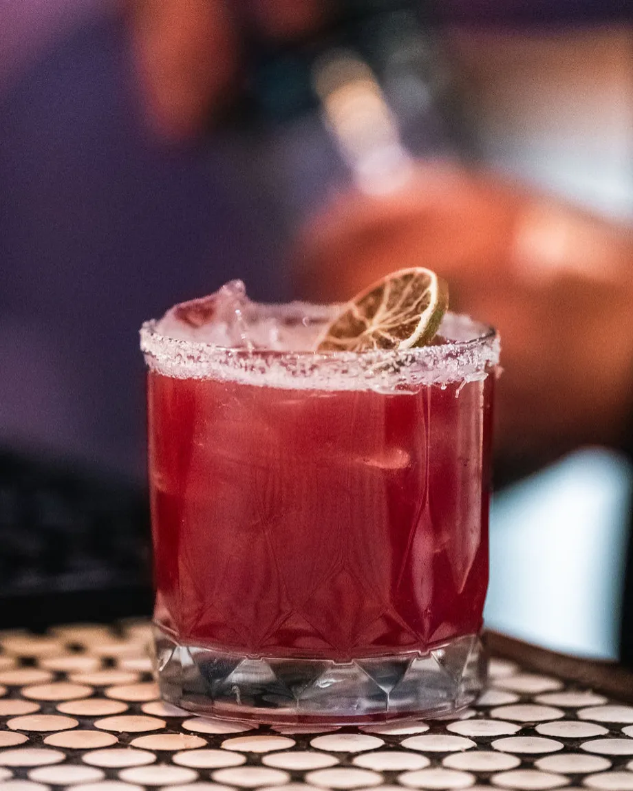 Cocktails on the hex-tile bar at Perro Negro Taperia, late-night pour