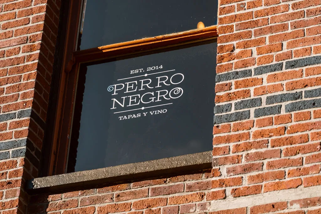 Perro Negro · Tapas y Vino · Est. 2014 — original window signage at 536 Yates Street