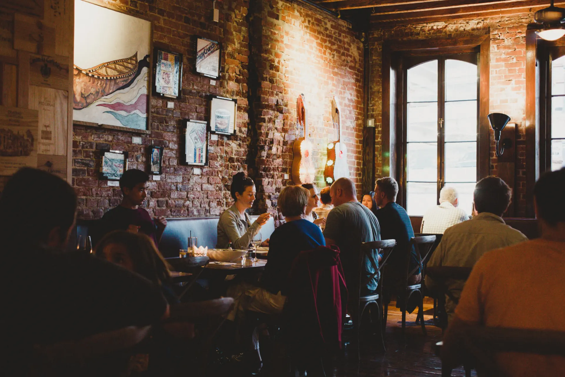 Guests sharing a long evening of tapas and wine in the Perro Negro dining room